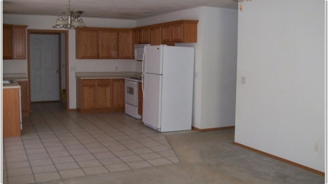 Kitchen appliances include stove, refrigerator, dishwasher and microwave