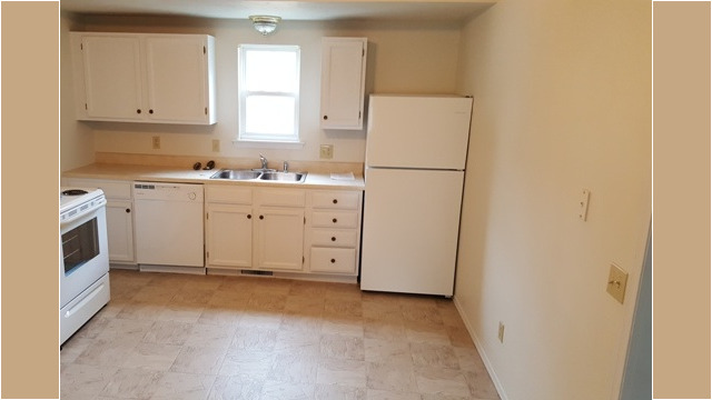 Kitchen appliances include stove, refrigerator and dishwasher
